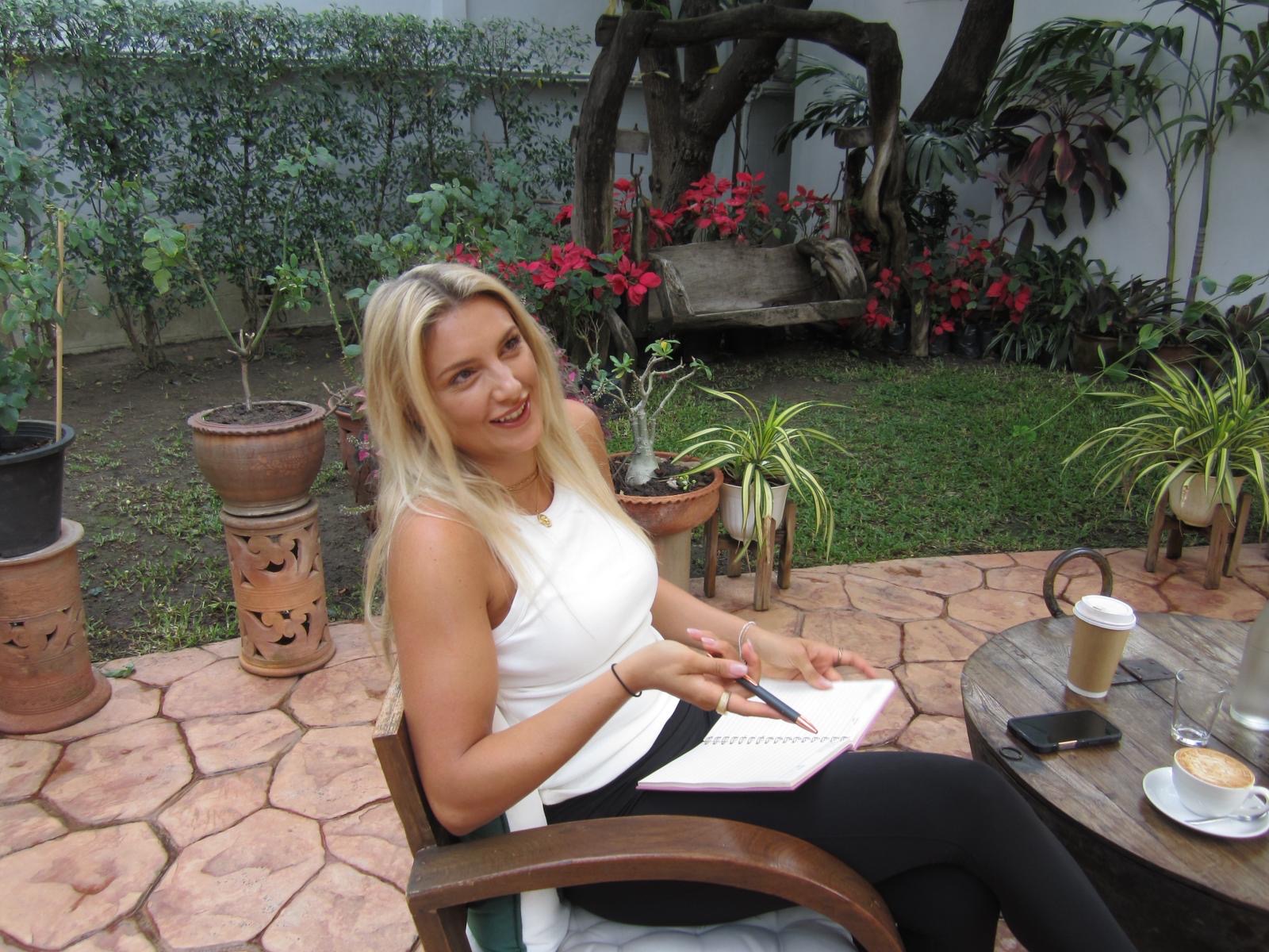 Logging the day's frames over coffee in a courtyard garden.