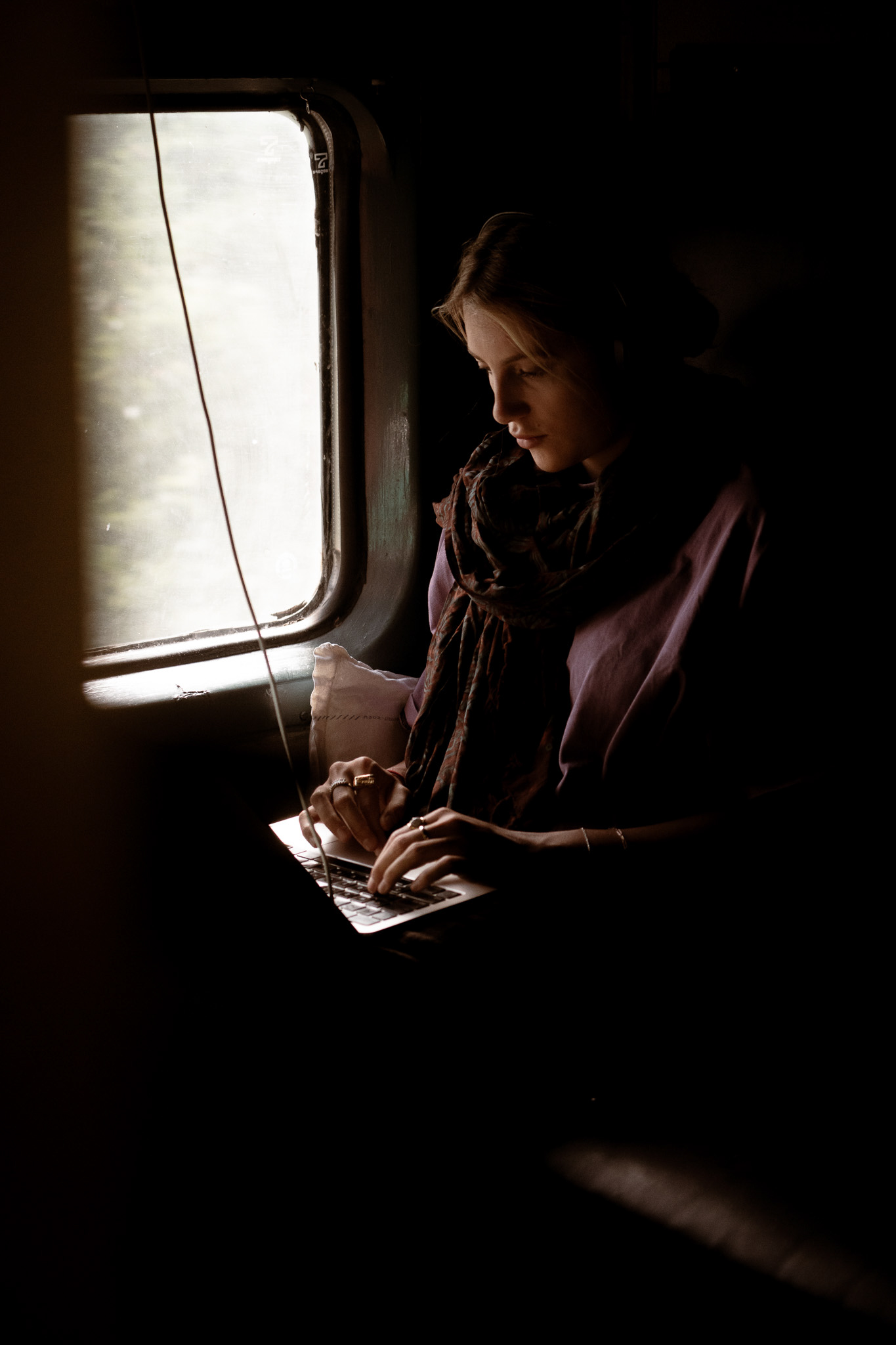 Editing notes on an overnight train, the only steady light coming through the carriage window.